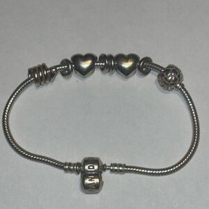 Authentic Sterling Silver Pandora Bracelet With 4 Charms and 4 Spacers